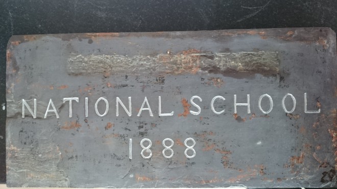 Stone plaque with name of school scratched out during WWII Photo:  © Michael Fisher